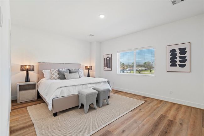 Welcome home to your spacious primary suite oasis. With room enough for seating, this space offers a serene retreat with abundant natural light, elegant flooring, and a well-designed layout perfect for relaxation. | Image 17