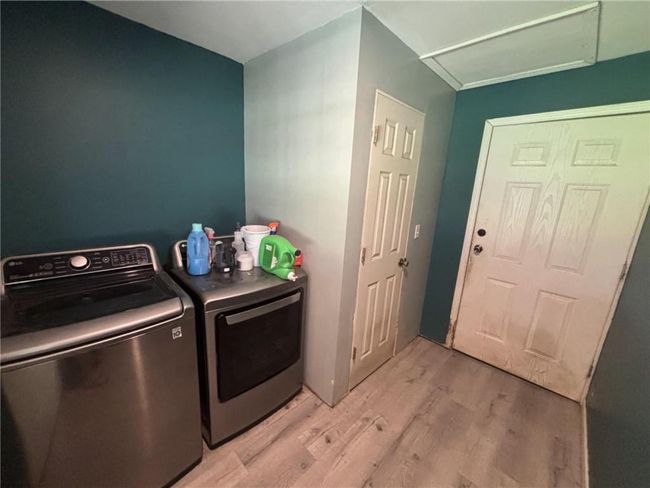Washroom with washing machine and clothes dryer and light wood-type flooring | Image 29