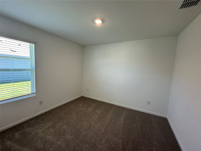 Spare room with dark carpet and baseboards | Image 16
