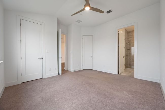 Unfurnished bedroom with carpet, ceiling fan, and ensuite bath | Image 22