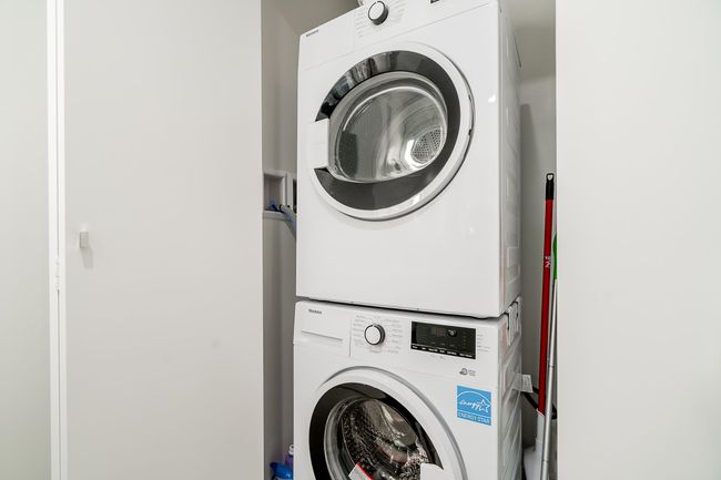Clothes washing area with laundry area and stacked washer and dryer | Image 27