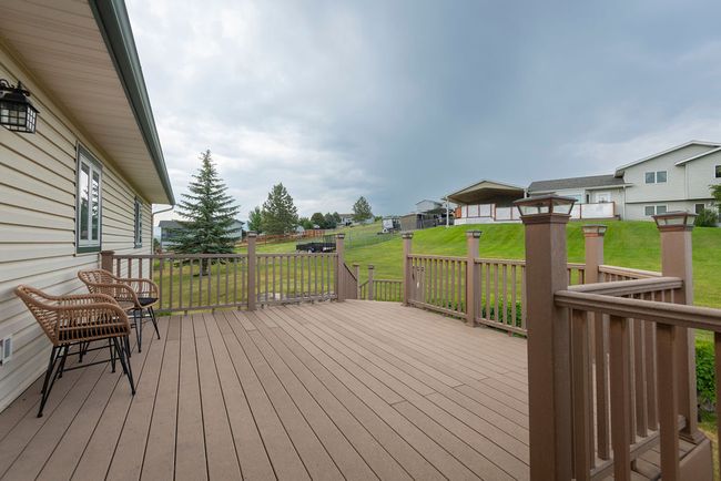 Deck with a lawn and a residential view | Image 27