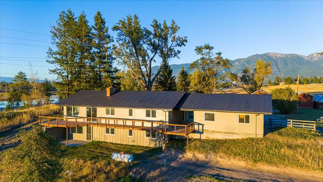 Back of property featuring a deck with mountain view and a yard | Image 46