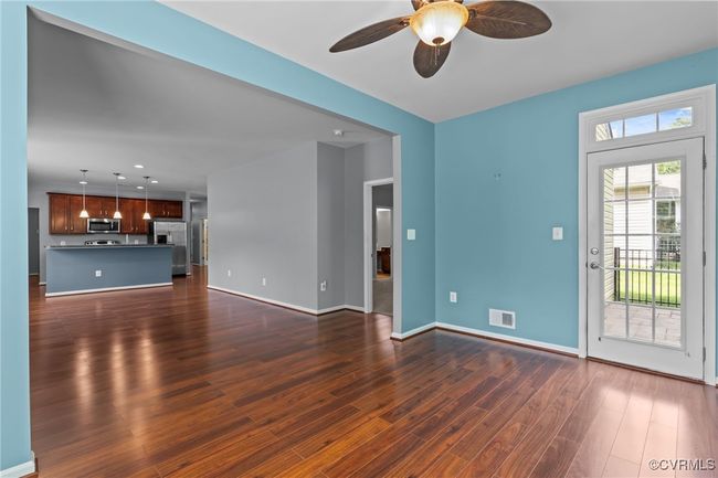 Unfurnished living room with dark wood-style floors, a ceiling fan, and recessed lighting | Image 16