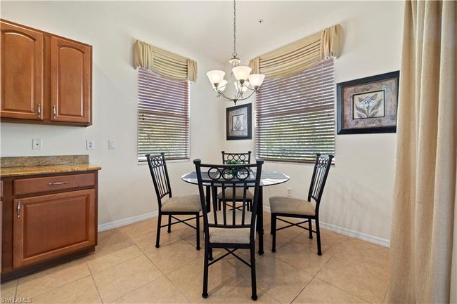 Dining room featuring baseboards, light tile patterned flooring, a chandelier, and a wealth of natural light | Image 17