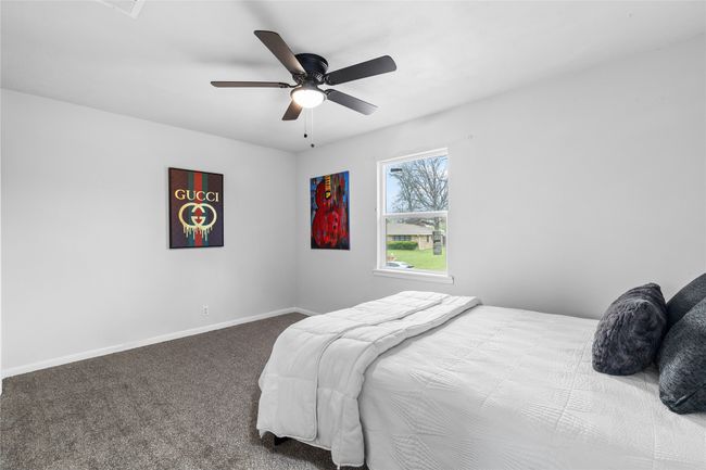 Bedroom featuring carpet flooring, ceiling fan, and baseboards | Image 22