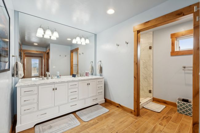 Bathroom with a tile shower and vanity | Image 55