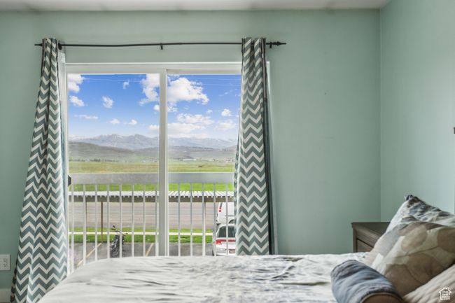 Bedroom with access to exterior and a mountain view | Image 9
