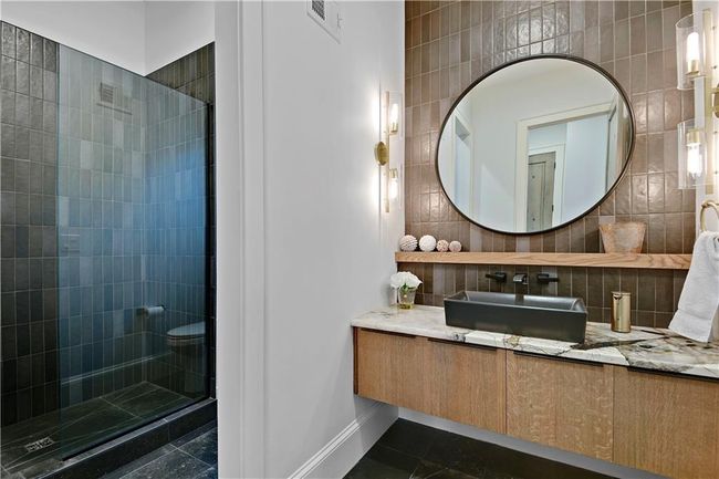 Full bath with tile walls, vanity, a shower stall, and tasteful backsplash | Image 57