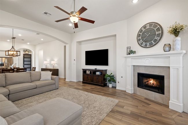 Living room features a cozy fireplace paired with a built-in entertainment nook—perfect for your media setup. | Image 18
