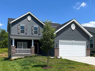 Craftsman-style home with a front yard, a garage, and a porch | Image 1