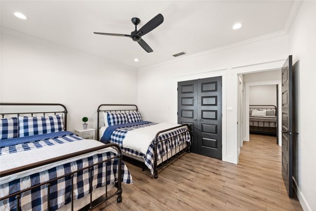 Bedroom with ornamental molding, light wood finished floors, recessed lighting, and a ceiling fan | Image 29