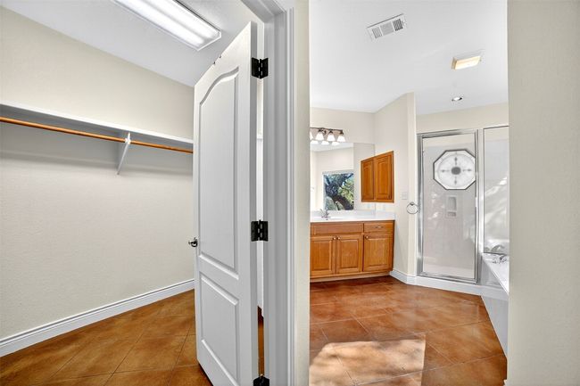 Primary bathroom with a separate shower, dual sink vanity, and a walk in spacious closet | Image 19