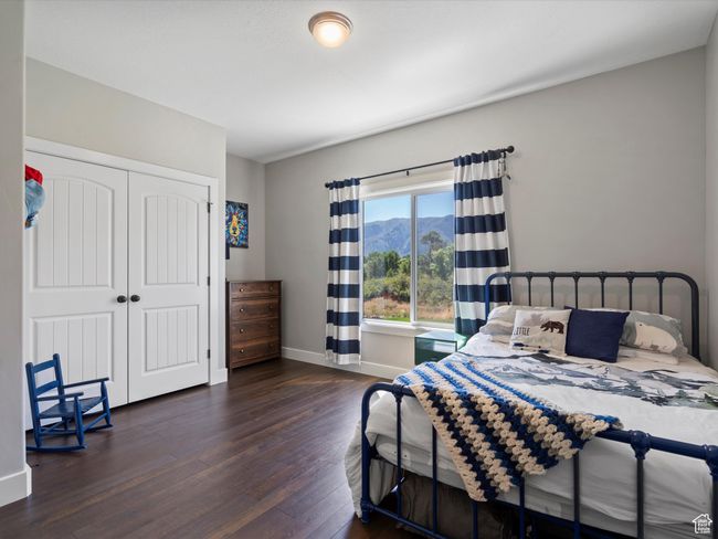 Bedroom with hardwood / wood-style flooring, baseboards, and a closet | Image 41