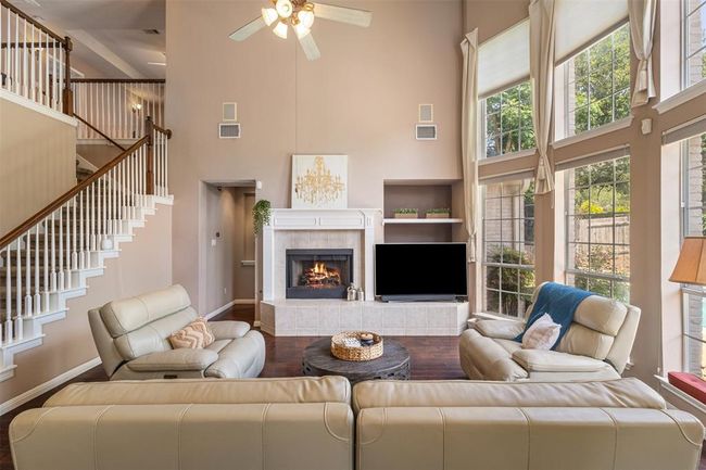 Gas log burning fireplace, built in shelves, and a built in speaker system in the home. | Image 10