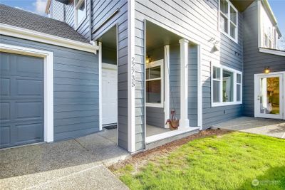 Welcoming entry with grassy area and patio. | Image 3