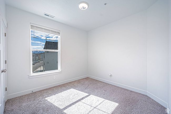 Carpeted empty room with visible vents and baseboards | Image 12