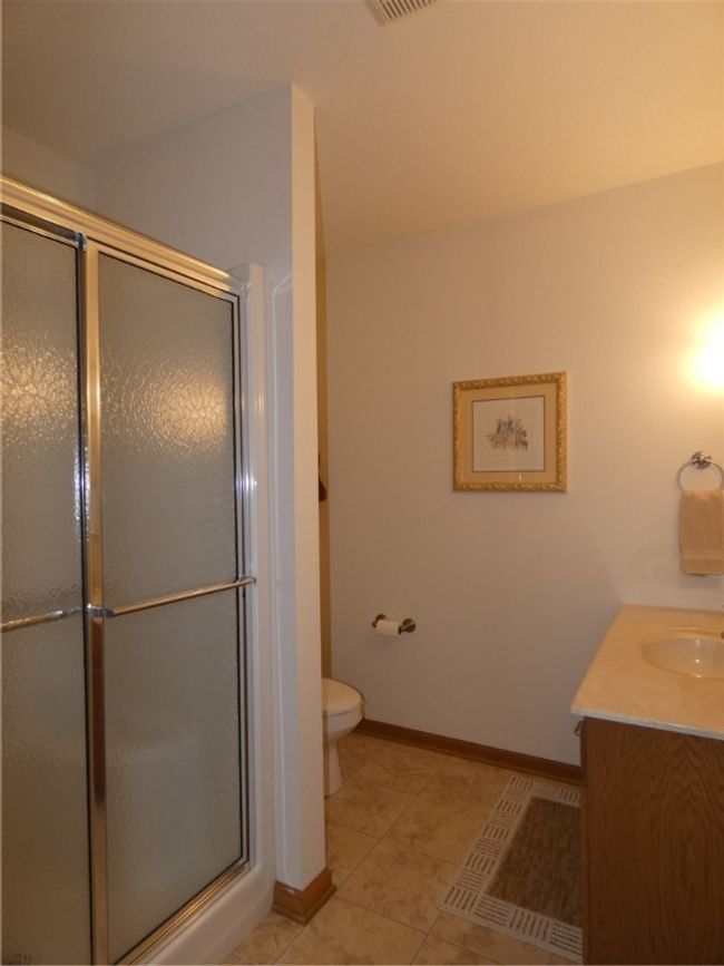 The third full bath is located on the lower level and is perfect for those overnight guests | Image 42