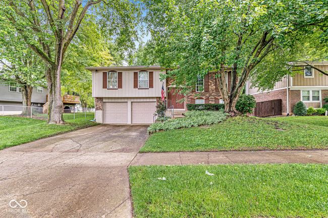 view of front of property featuring brick siding, driveway, and an attached garage | Image 24