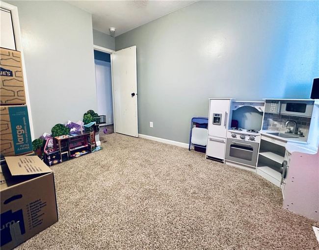 Game room featuring carpet, a sink, and baseboards | Image 16