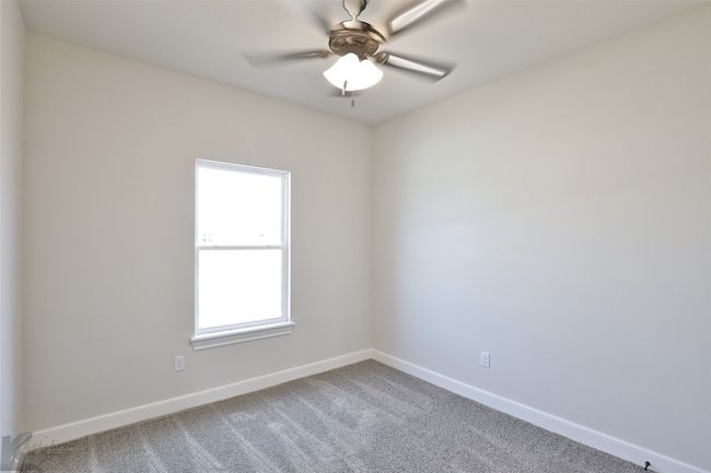 Carpeted spare room featuring baseboards and a ceiling fan | Image 25