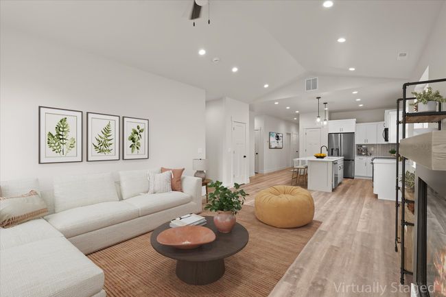 Living area featuring lofted ceiling, recessed lighting, light wood finished floors, ceiling fan, and visible vents | Image 4