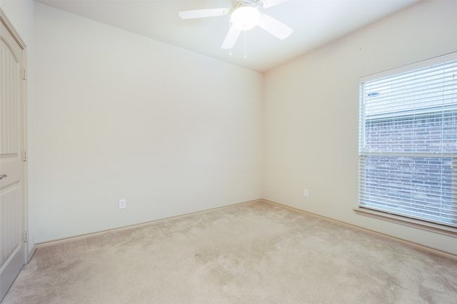 Spare room featuring light colored carpet and a ceiling fan | Image 15