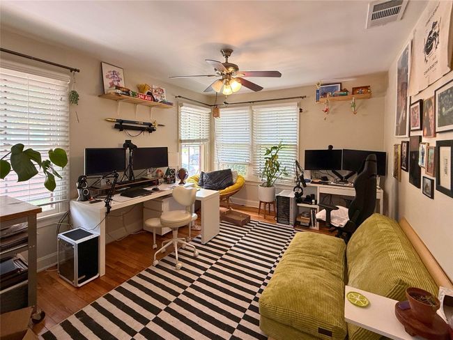 Office space with a ceiling fan and wood finished floors | Image 14
