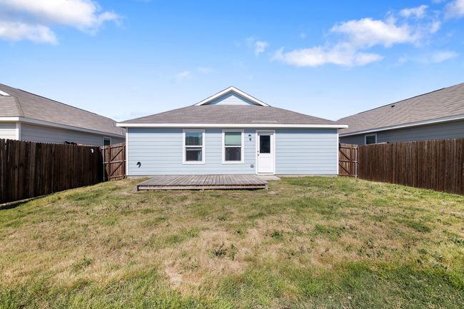 Rear view of property featuring a fenced backyard and a lawn | Image 19