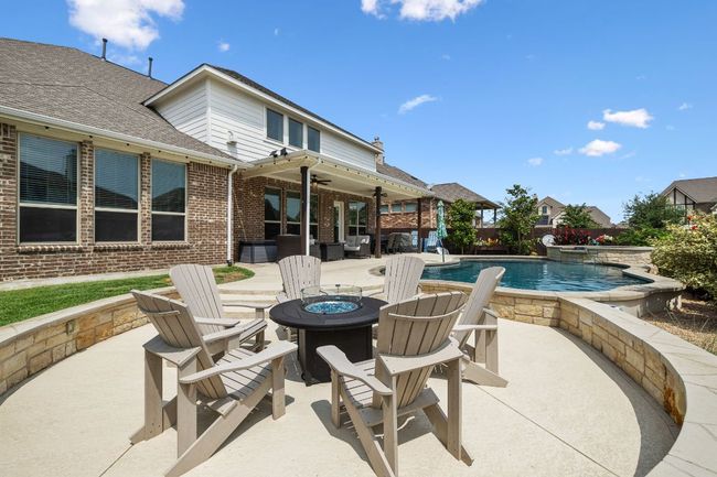 View of patio / terrace with an outdoor fire pit, a ceiling fan, and an in-ground hot tub | Image 5
