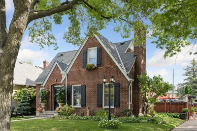 Fall in love with this beautiful all-brick home in Victory Memorial! Its timeless facade, meticulously maintained, invites you into a world of luxury and comfort, with modern upgrades throughout. | Image 1