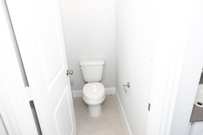 Bathroom with tile patterned flooring and toilet | Image 14