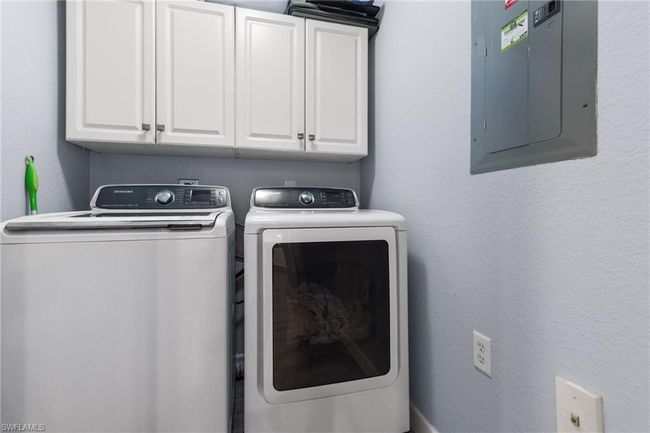 Laundry room with cabinets, electric panel, and washer and clothes dryer | Image 20