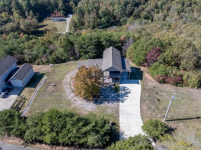 Wide Concrete Drive with parking on Covered Carport. The Single Car Garage is in Basement | Image 12