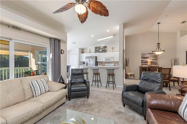 Living room featuring ceiling fan and lofted ceiling | Image 13