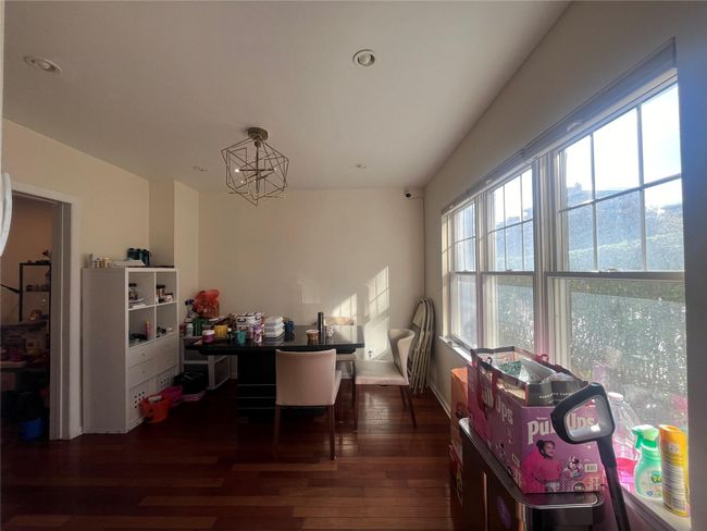 Dining space with recessed lighting, wood finished floors, and a notable chandelier | Image 5