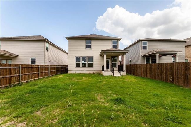 Back of house with a fenced backyard and a patio | Image 6