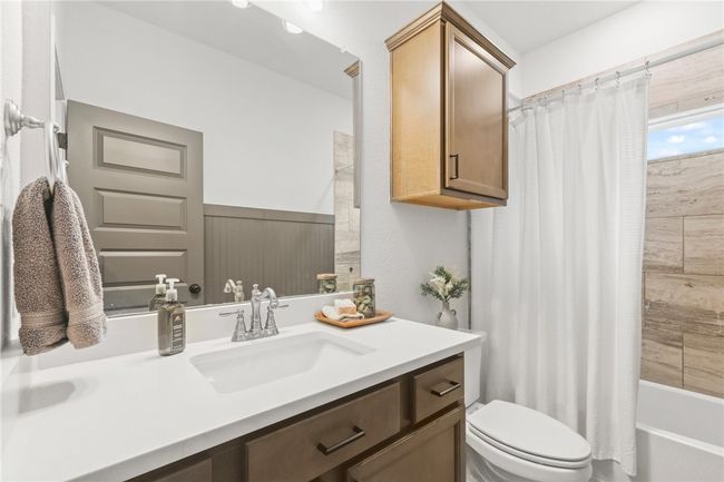 Bathroom featuring vanity and shower / bath combo | Image 7