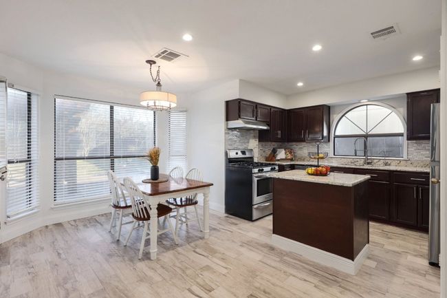 In the kitchen, you’ll feel like a chef as you work with the beautiful granite countertops, giving you all the space you need to create meals or simply enjoy a little snack in the cozy breakfast nook | Image 8