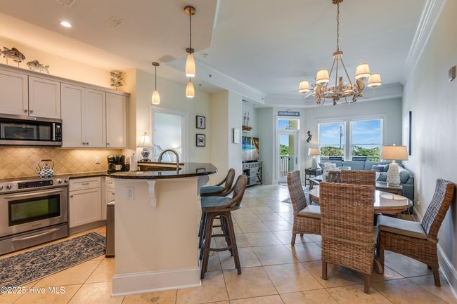 Built with LUXURY in mind, the interior features of Unit C1 include limestone flooring and newer LVP flooring(2021), granite kitchen countertops, marble in the primary bath, and soaring 10 ft. ceilings throughout. | Image 7