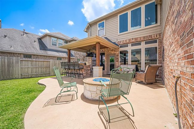 Whether roasting marshmallows or sipping wine, this built-in fire pit with stone surround sets the stage for unforgettable evenings outdoors. | Image 43