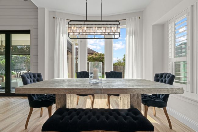 Dining space featuring a chandelier, light wood-style flooring, and baseboards | Image 14