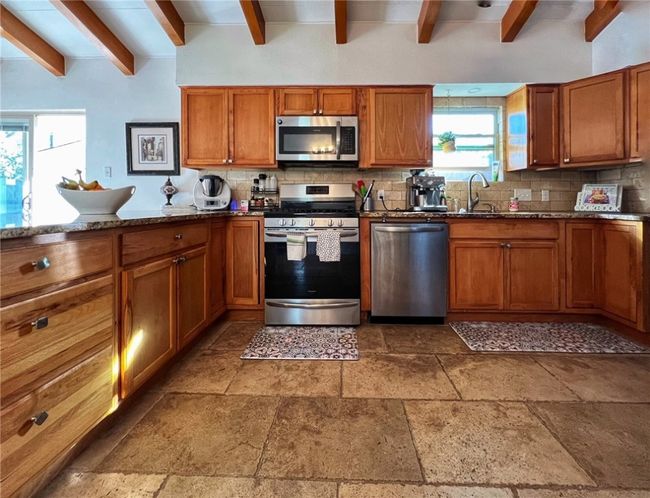 LARGE KITCHEN WIT STONE FLOORS. LOTS OF STORAGE. GAS COOKING. SEP LAUNDRY ROOM TO THE RIGHT WITH ACCESS TO GAR. STAINLESS APPLIANCES. REF INCLUDED | Image 9