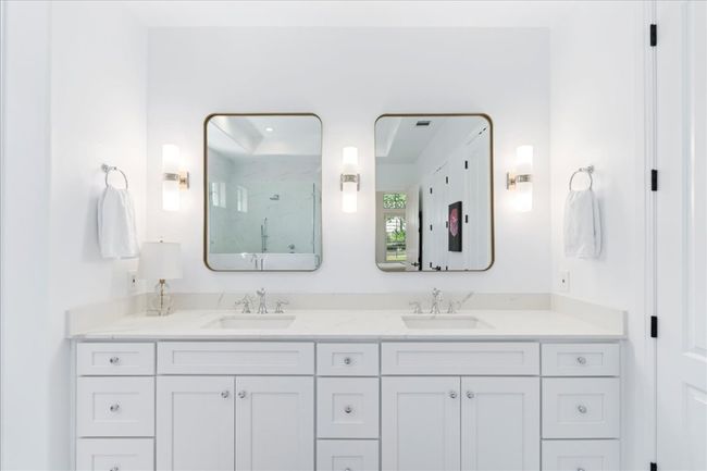 Bathroom with a marble finish shower and double vanity | Image 20
