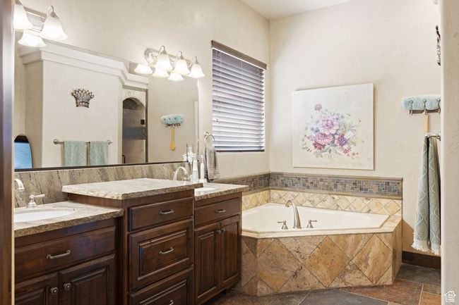 Full bathroom with two vanities, a garden tub, and stone tile floors | Image 24