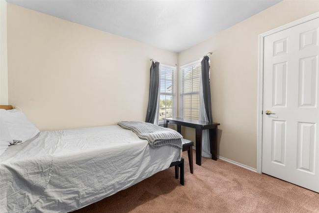Bedroom featuring light carpet and baseboards | Image 21