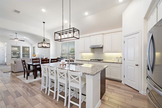 Chic lighting adds a designer touch to this well-appointed kitchen with a functional layout. | Image 10