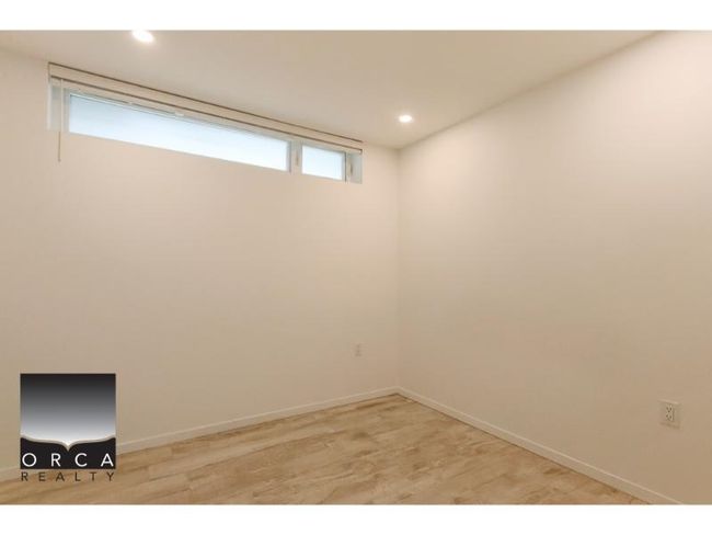 Basement with light wood-style flooring and recessed lighting | Image 8