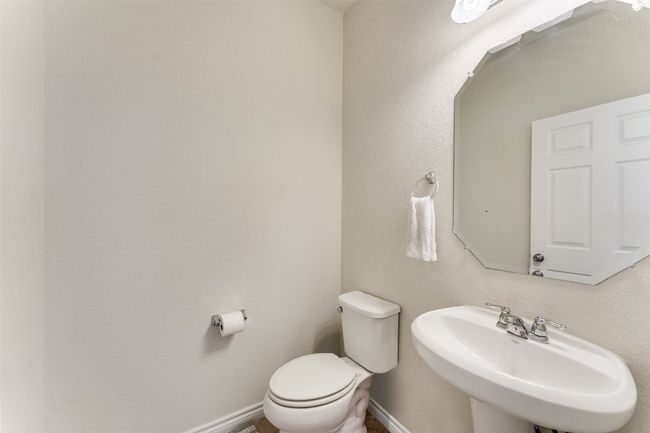 moving back downstairs, we have a half bath for guests immediately to the left as one enters the home. | Image 22