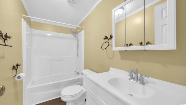 Bathroom with crown molding, vanity, and washtub / shower combination | Image 12